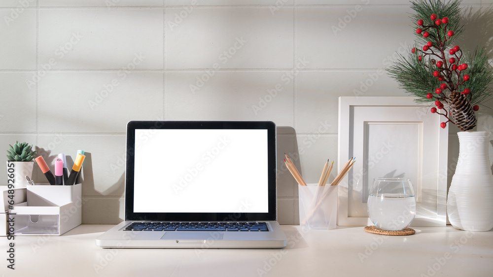 Poster front view laptop computer with empty screen on white table in bright room.