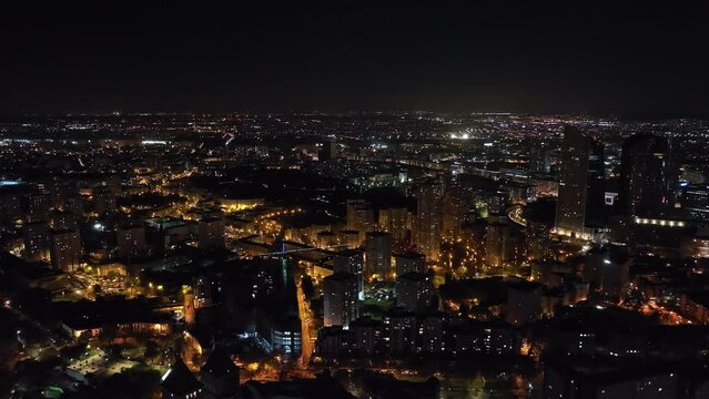 By night, Paris' financial core contrasts ancient streets with modern luminosity.
