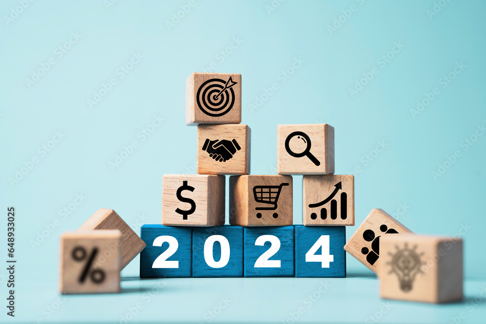 Poster 2024 on wooden block cube and business icons include hand shaking, target,percentage and lightbulb f