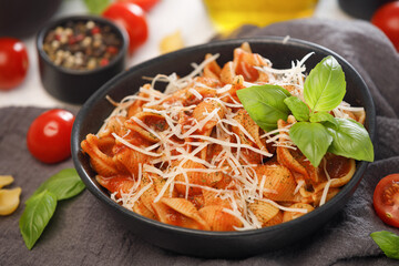 Conchiglie rigate pasta in tomato sauce with parmesan cheese. Traditional italian cuisine