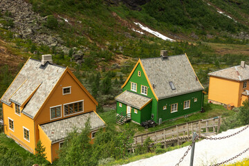 Fototapeta na wymiar Colorful wooden cottages in Myrdal, near the railway station. Myrdal is an area with some cottages and hotels, in Aurland, Vestland County. Norway