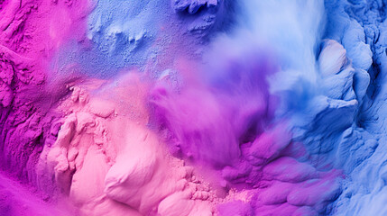 Make-up brush with pink and blue powder explosion on dark background