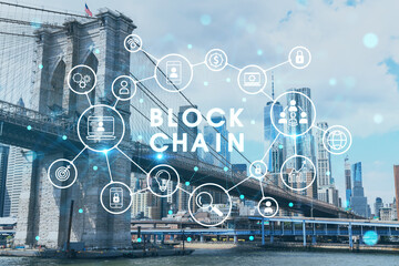 Brooklyn bridge with New York City Manhattan, financial downtown skyline panorama at day time over East River. Decentralized economy. Blockchain, cryptography and cryptocurrency concept, hologram