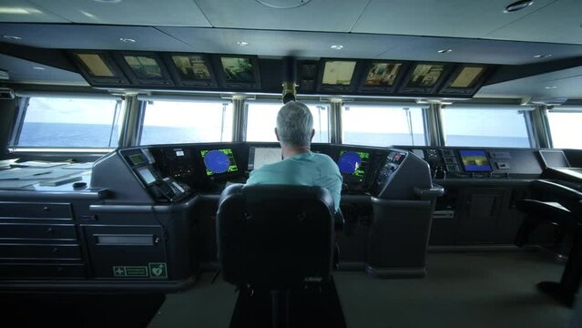 Captain Sitting In Control Center of Ship