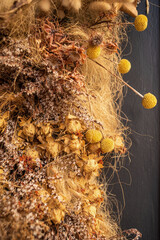 Decor of dried flowers on the wall. A bouquet of dried flowers. Floral minimalist home interior in boho style. The decor of the festive photo zone in the boho style.