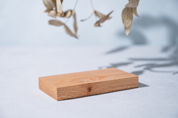 Wooden board empty for product demonstration or mock-up on a blue background with shadow and...