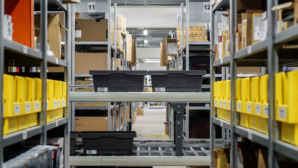 Yellow plastic boxes on a metal rack and conveyor line