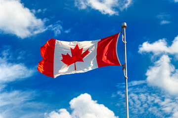 Canadian flag against blue sky