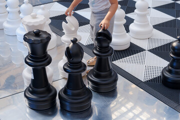 Little boy playing chess. Little boy playing chess with black and white figures
