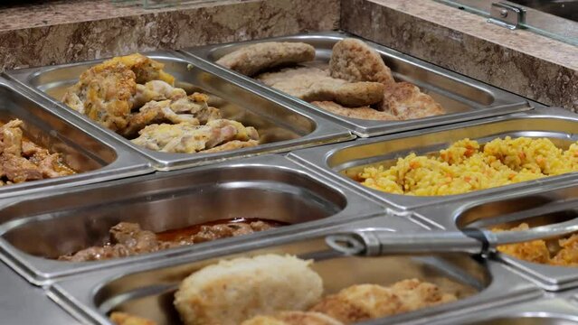 Patches with food on the bistro counter, meat and garnish in patches. Fast food bistro, low income charity kitchen, food stand.