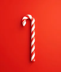 Tuinposter Christmas candy cane on bright red background © Boadicea