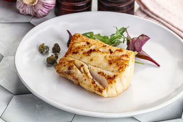 Roasted cod fish steak with salad