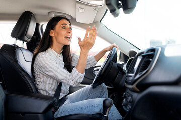 Woman driver stuck in traffic jam gesturing with hand, screaming - obrazy, fototapety, plakaty