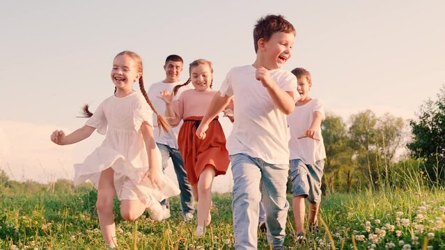 Family mom dad kids, weekend outdoors. Children, parents run in park, friends play in summer. Concept of happy childhood dream. Happy boy girl run, play together, nature. Kids run, healthy lifestyle