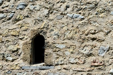 small window on the stone church