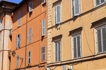 Fototapeta na wymiar Trastevere House Facades with Windows and Shutters Close Up in Rome, Italy