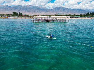 Man rowing with Stand Up Paddle Board on a lake