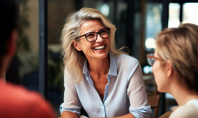 Wisdom Shared with a Smile: Mature Coach and Eager Interns at Workshop.