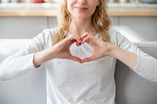 Woman showing love, like gesture and express gratitude and appreciation,