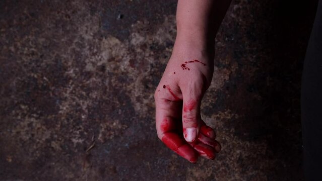 Hand of a maniac or murderer or victim in blood close-up