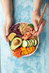 poke bowl salmon with quinoa and vegetables, healthy nutrition, top view