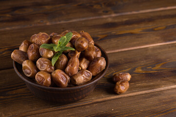 dates in a plate on a wooden table
