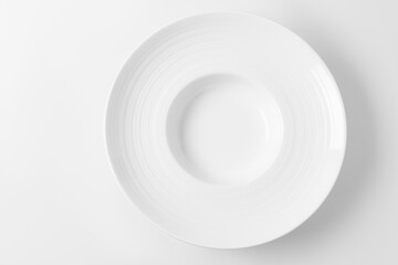 Empty large white plate on a white background, top view