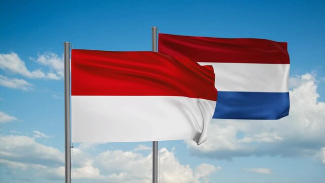 Netherlands flag and Indonesia flag waving together on blue sky, looped video, two country cooperation concept
