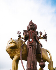 The giant Shiva statue of Durga at the Hindu temple Ganga Talao, Grand Bassin, Mauritius. Panoramic...