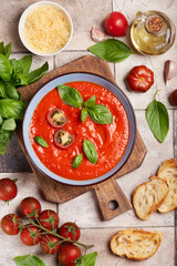 Tomato soup served with parmesan cheese and basil leafs. Gazpacho. Vegetarian dish. Top view
