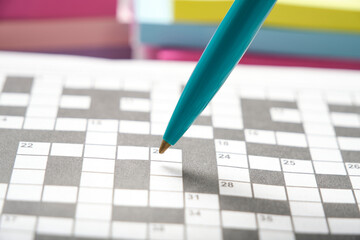 Green ballpoint pen background crossword puzzle sheet.
