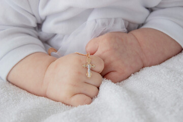 hand of a child with a cross, baptism of a child.