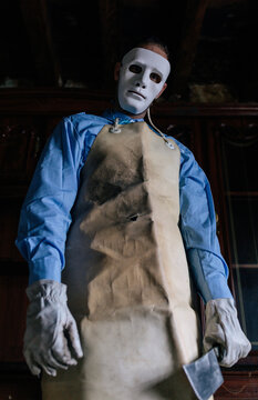 Anonymous terrifying man in butcher costume celebrating Halloween