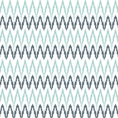A blue and white zigzag ikat pattern on a white background