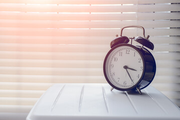 Close up alarm clock at the window area