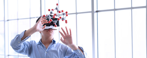Boy using VR glasses learning molecular model chemistry science at home. Child Wearing Augmented...