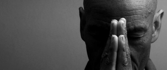 man praying to god with hands together Caribbean man praying on black background with people stock photos stock photo	