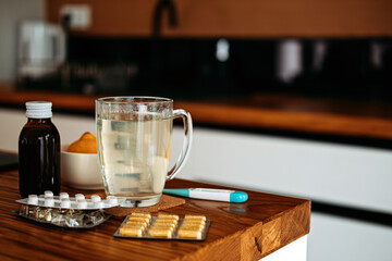 Natural and medical cold and flu remedies on table at home. Cold and flu influenza fall autumn and...