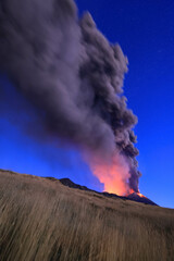 Etna durante suggestiva eruzione all'alba con grandi emissioni di cenere nel cielo stellato dal cratere della cima del vulcano - 13 Agosto 2023.
