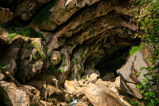 Crystal clear water washing on rough rocky cave