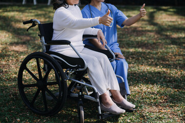 Fototapeta premium Asian young woman nurse at nursing home take care disabled senior man. Caregiver doctor serve physical therapy for older elderly patient to exercise and practice walking on walker or cane at backyard.