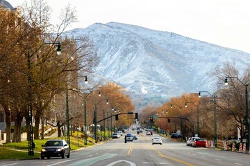 City of Contrast: 4K Panoramic View of Salt Lake City Roads Amidst Snow-Capped Mountains