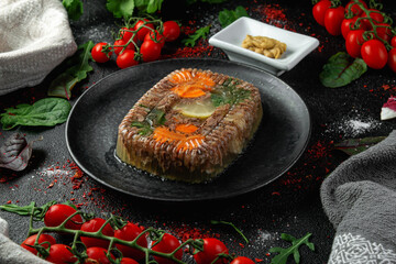 Meat aspic in a dark plate with mustard. Black background. Restaurant dishes