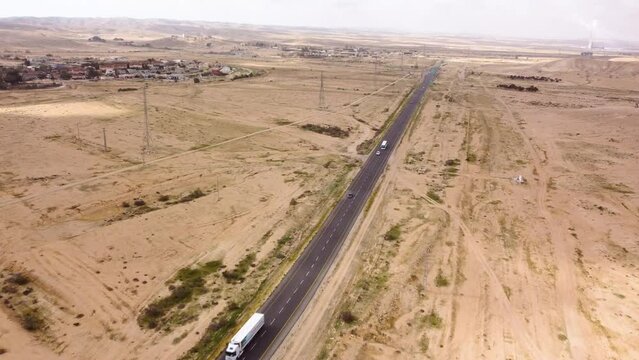Flying over the highway with cars traffic in the desert Negev on the southern direction to the solar power plant