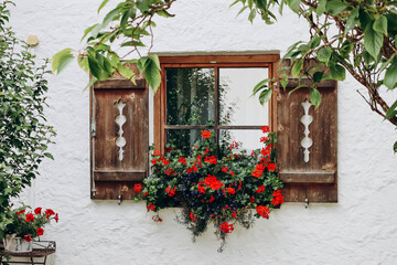 Beautiful wooden window with carved shutters in the village of Fulpmes, Austria