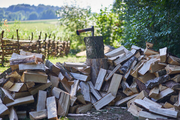 Preparation of chopped wood for the heating of the house in the winter during sunny autumn day in the indian summer period. Old fashioned style of heating still popular in the countryside of Czechia.