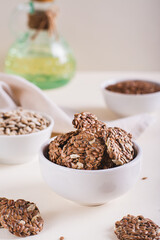 Crispy baked bread from flax and sunflower seeds in a bowl on the table vertical view