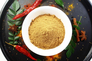 multi purpose indian spicy chat masala or curry masala powder in bowl for pani puri,bhel puri,salad,vegetarian or non vegetarian cooking on black background,food,health related concept,top view - obrazy, fototapety, plakaty