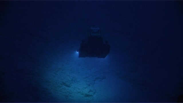 Submarine Slowly Rising Near Underwater Mountain