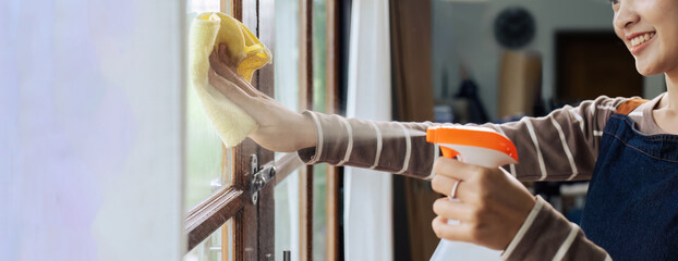 Hands with napkin cleaning window. Washing the glass on the windows with cleaning spray